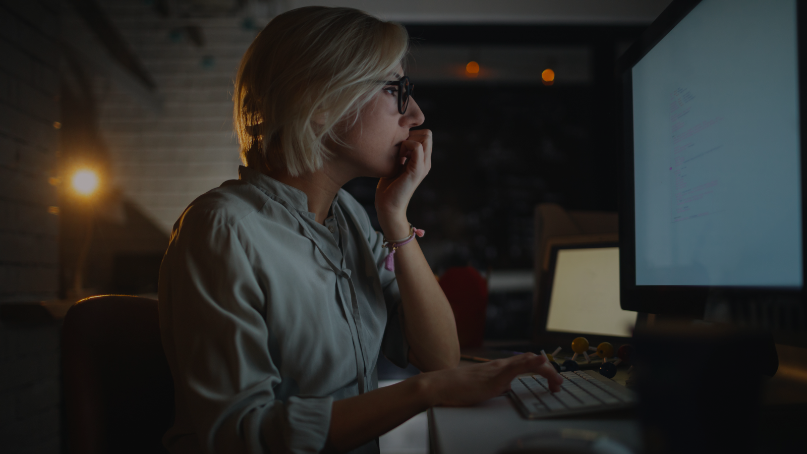 a person sitting at a desk in front of a computer