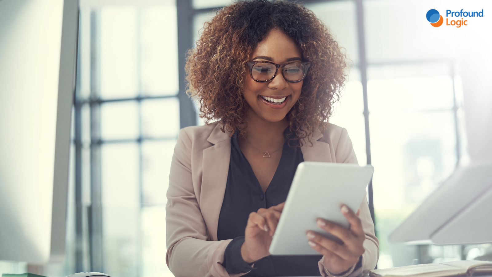 smiling person using digital tablet in office