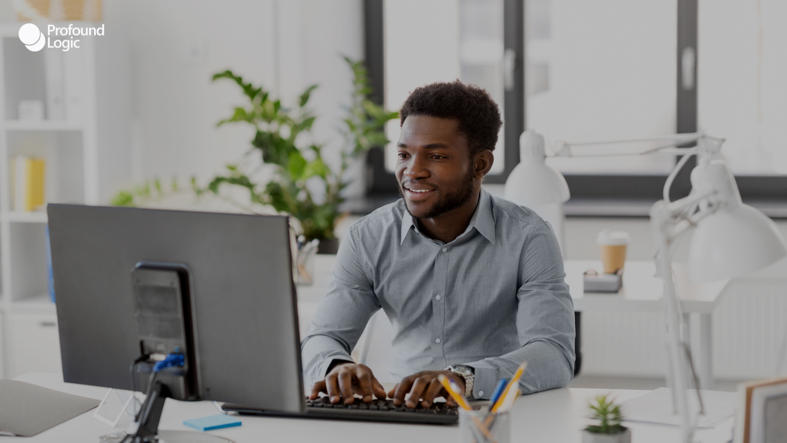 an individual sitting at a desk in front of a computer