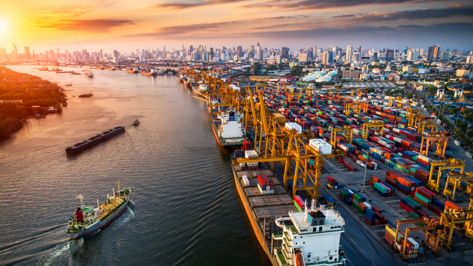 an aerial view of a port and city at sunset