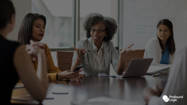 a group of business people sitting around a conference table