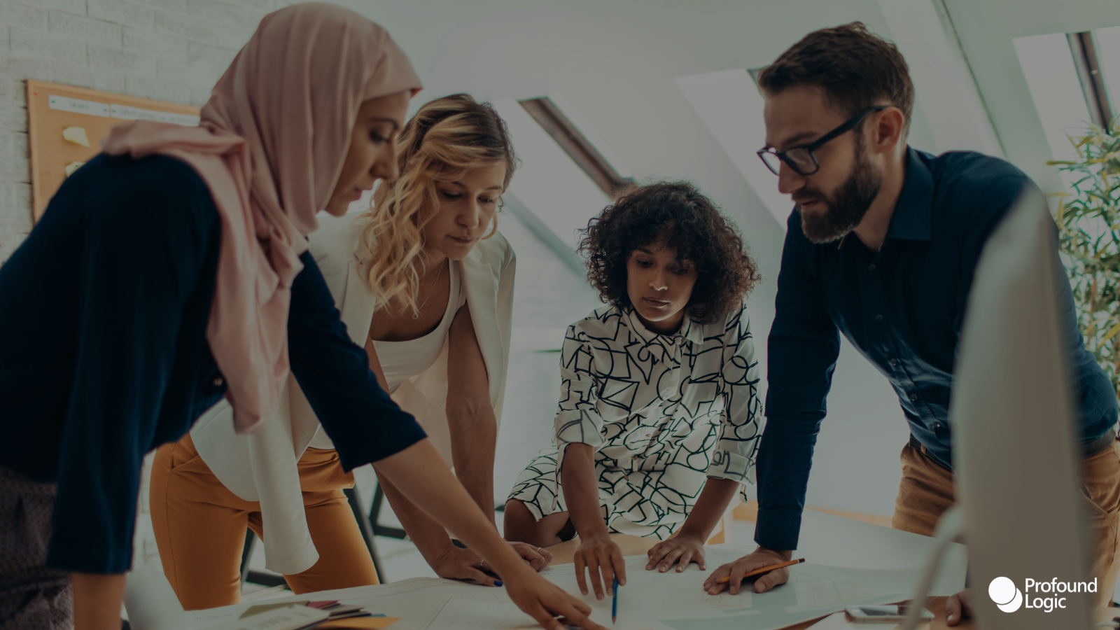 a group of people working together in an office