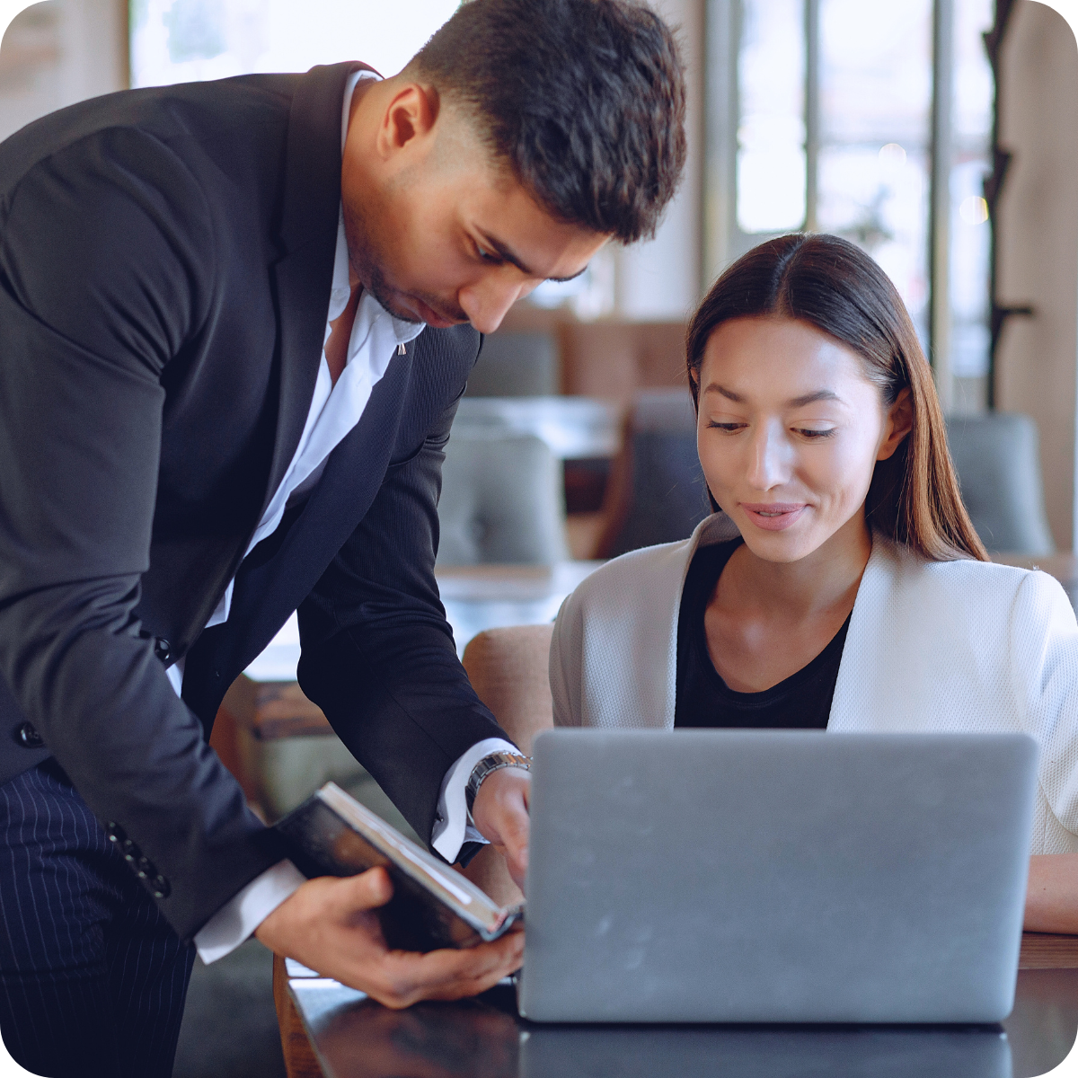 two people collaborating over a laptop