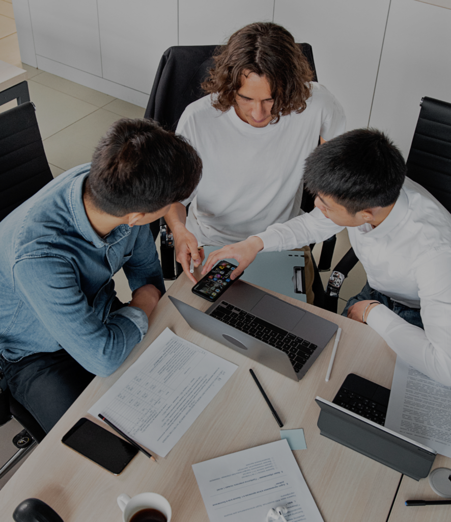 3 people working together over laptops